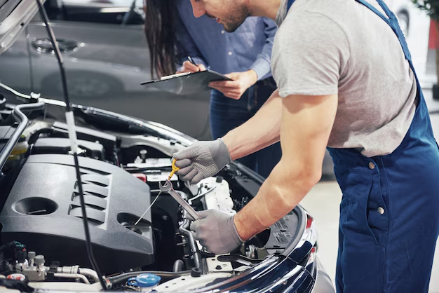 A mechanic repairing a car